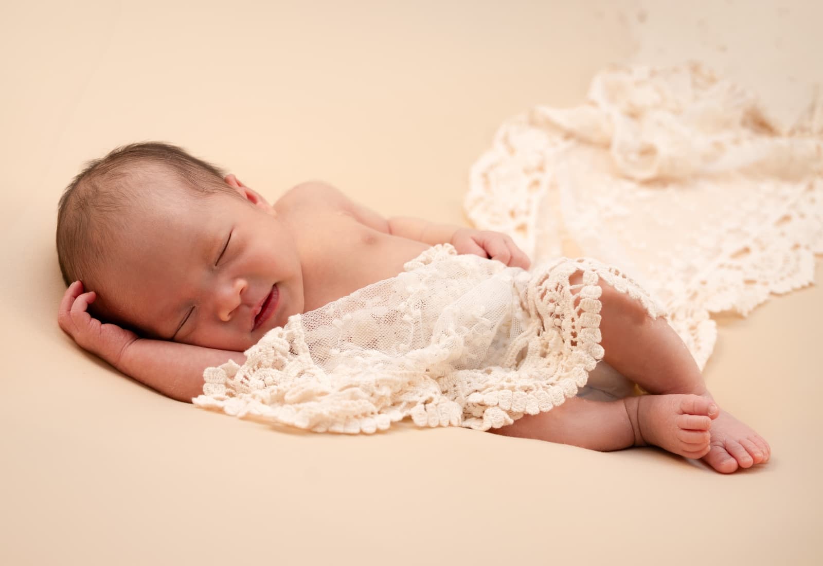 Sleepy newborn on lace