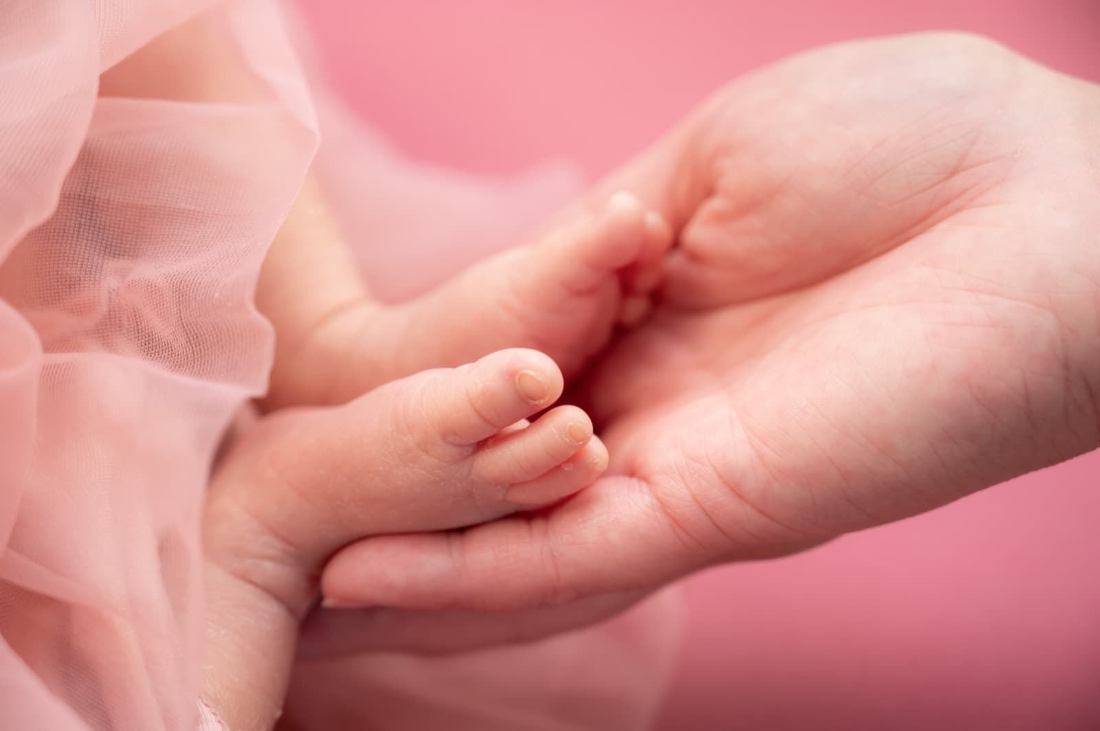 Tiny foot in hand
